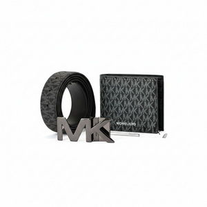 Straight-on view of a Michael Kors men's black gift set featuring a monogram patterned wallet, reversible belt, rotating MK buckle, and sizing tool
