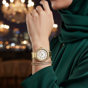 Modest woman wearing Michael Kors MK3312 gold watch and matching bangle on hairless wrist