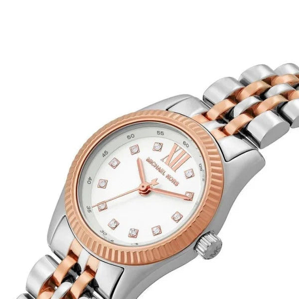 Extreme close-up of Michael Kors MK4817 rose gold fluted bezel and polished crown