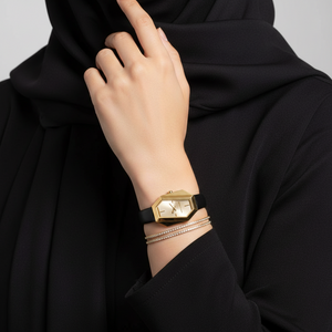 Modest woman wearing Michael Kors MK4880 gold hexagonal leather watch on hairless wrist