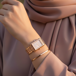 Modest woman wearing Michael Kors MK4905 rose gold rectangular watch on hairless wrist