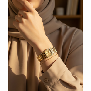 Modest woman wearing Michael Kors MK4931 gold square watch on hairless wrist
