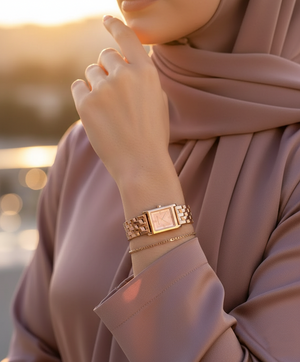 Modest woman wearing Michael Kors MK4932 rose gold square watch on hairless wrist