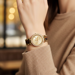 Elegant woman wearing Michael Kors MK6109 gold and tortoise watch on smooth hairless wrist