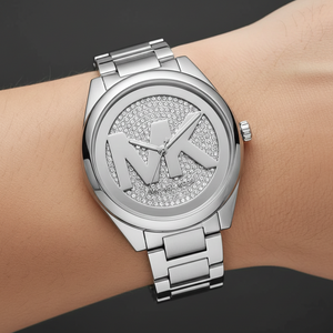 Extreme close-up of Michael Kors MK7311 showing silver MK logo on crystal background