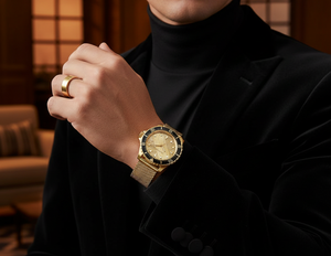 Stylish man wearing Michael Kors MK9083 gold mesh watch on clean hairless wrist