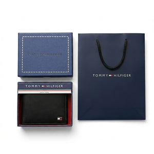 Full premium presentation of the Tommy Hilfiger mirror original smooth black leather wallet with its matching detachable card case set, navy gift box, and shopping bag