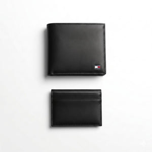 Straight front view product photography of the Tommy Hilfiger mirror original black leather wallet alongside its matching slim card case with vertical ribbon details