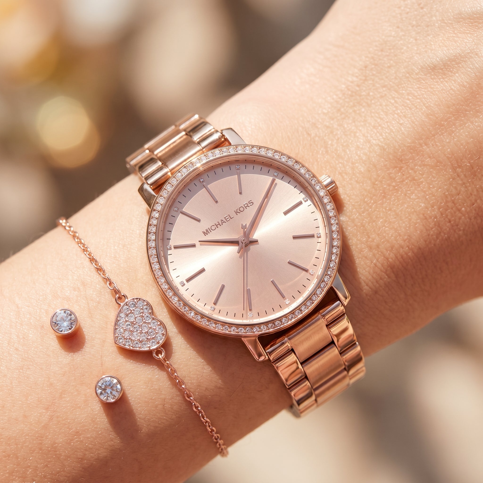 Close up shot of Michael Kors MK1040 on wrist showing rose gold sunray dial and crystal bezel