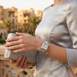 Lifestyle photo of Michael Kors MK1219 showing the delicate silver watch on a woman's wrist