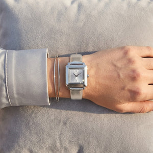 Close up shot of Michael Kors MK1219 on wrist showing petite square silver case and pavé crystals