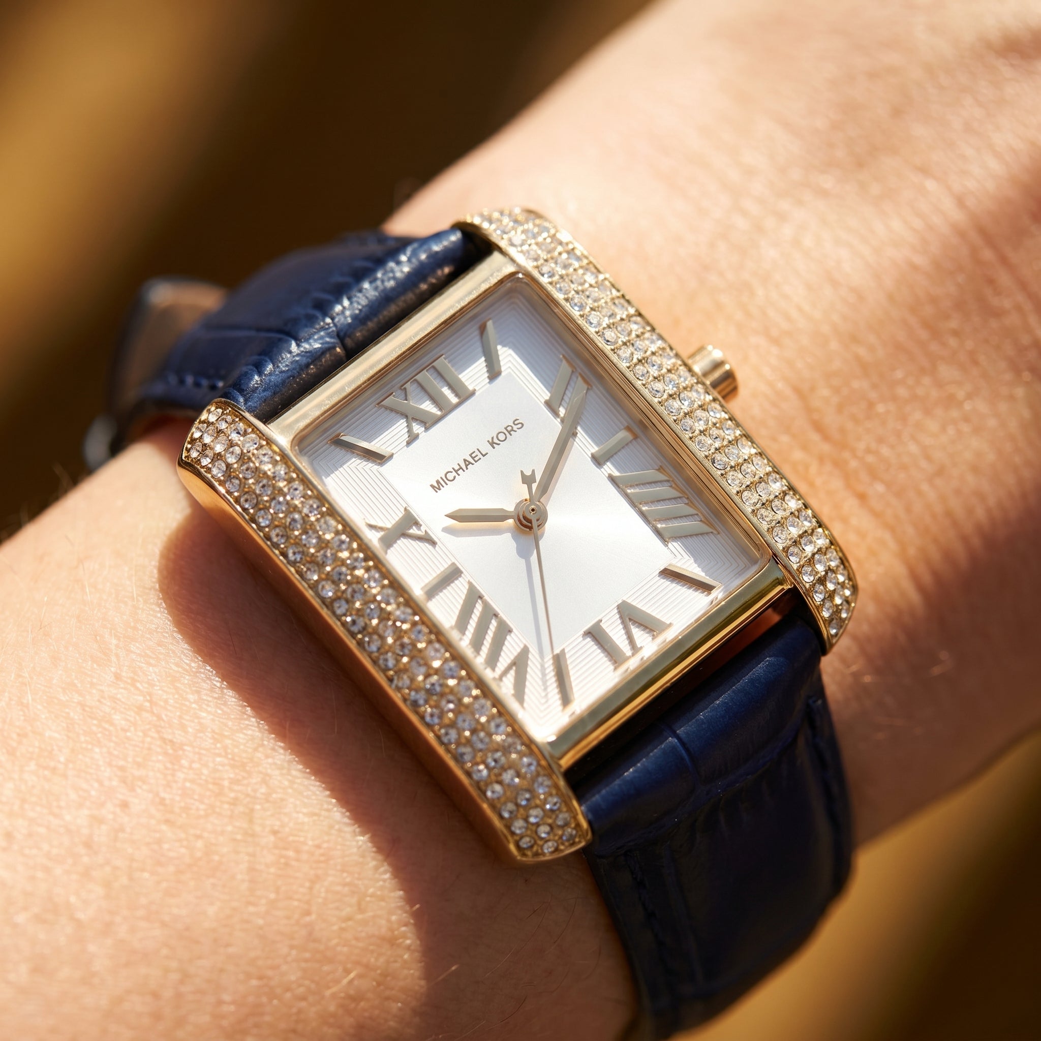 Close up shot of MK2982 highlighting the white dial and gold roman numerals with crystal accents