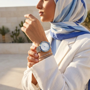 Elegant woman wearing Michael Kors Darci MK4516 with silver case and stunning blue crystal bezel jewelry style watch