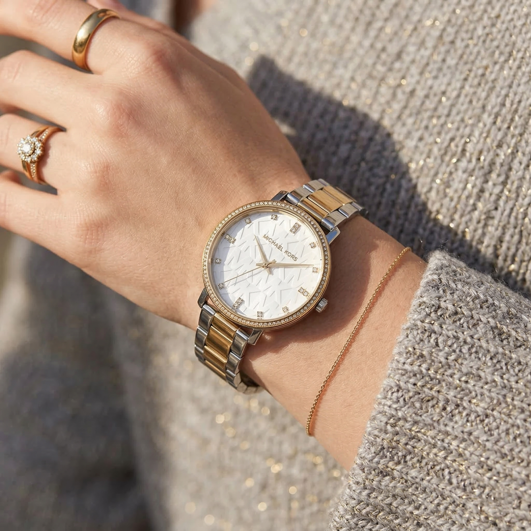 Close up of Michael Kors Pyper MK4595 women's quartz battery watch on wrist showing white MK logo dial and two-tone metal bracelet