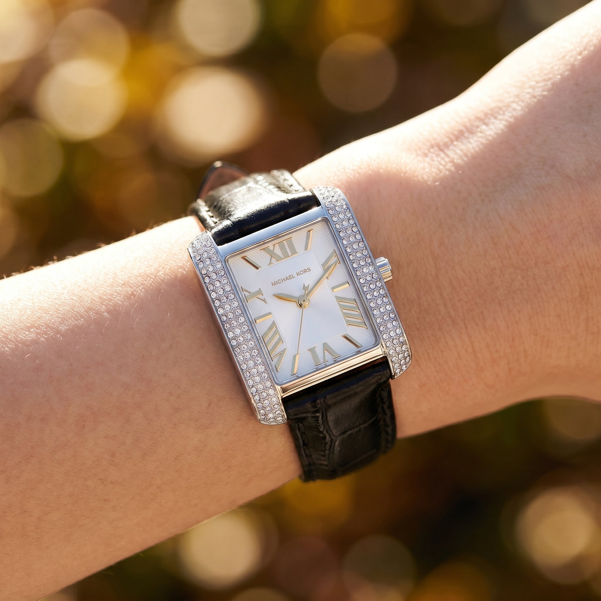 Close up shot of MK4696 showing the white sunray dial with gold-tone roman numerals and crystal accents