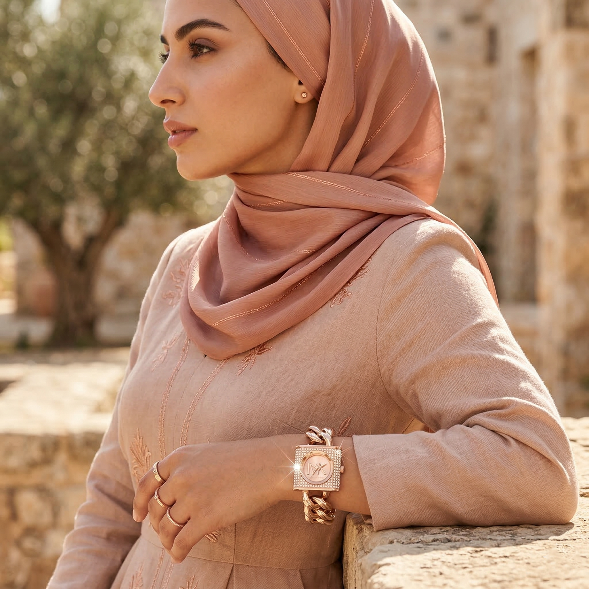 Elegant woman wearing Michael Kors Camille MK4827 with rose gold-tone case and brilliant pavé dial luxury style watch