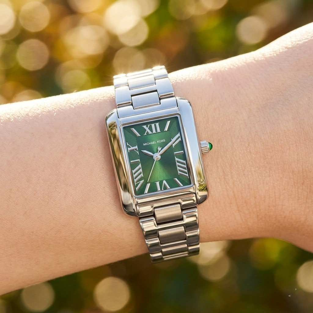 Close up shot of Michael Kors MK4832 on wrist showing green dial and silver-tone Roman numerals