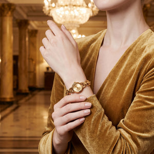 Lifestyle photo of Michael Kors MK4871 showing the elegant gold watch on a woman's wrist
