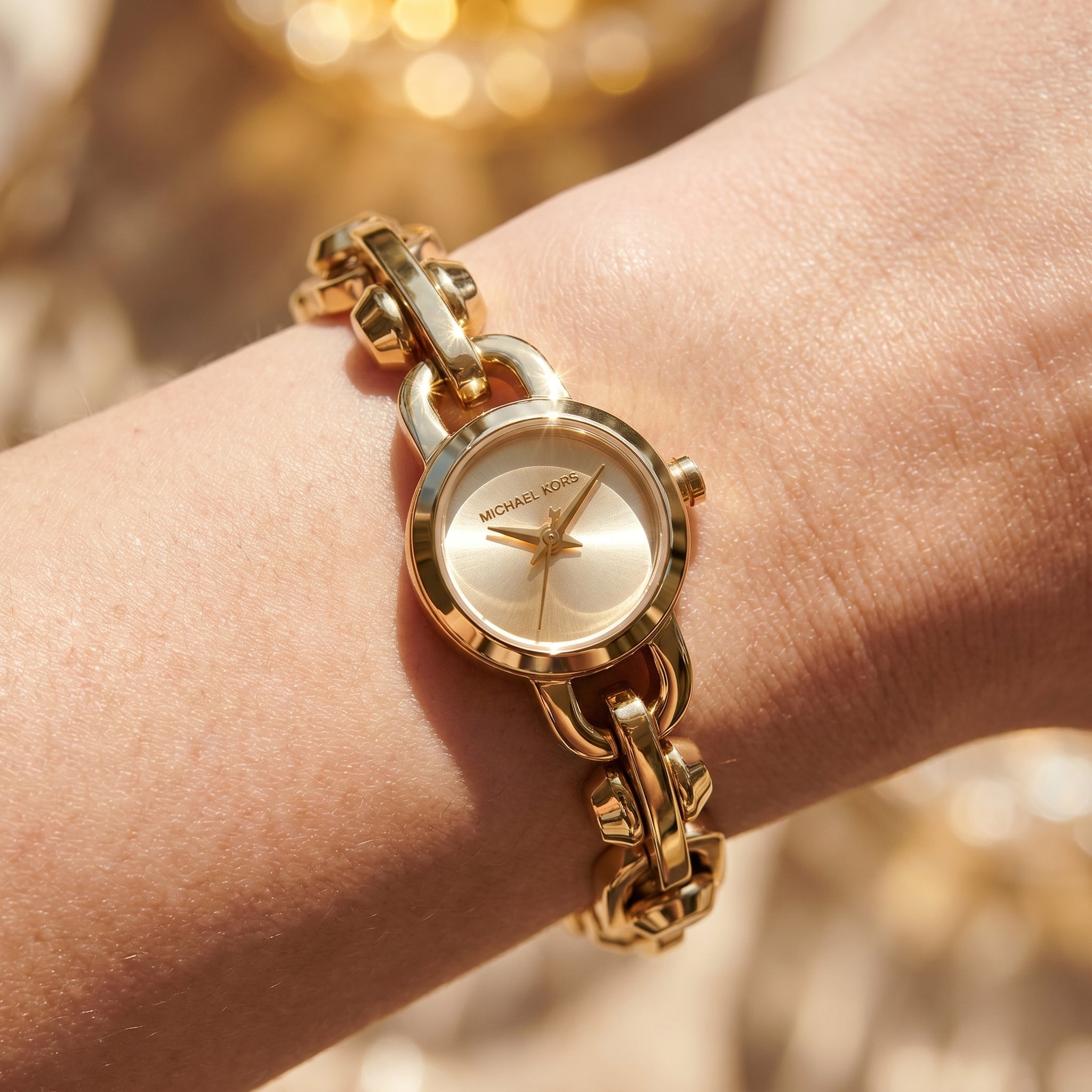 Close up shot of Michael Kors MK4871 on wrist showing the delicate chain bracelet and gold dial