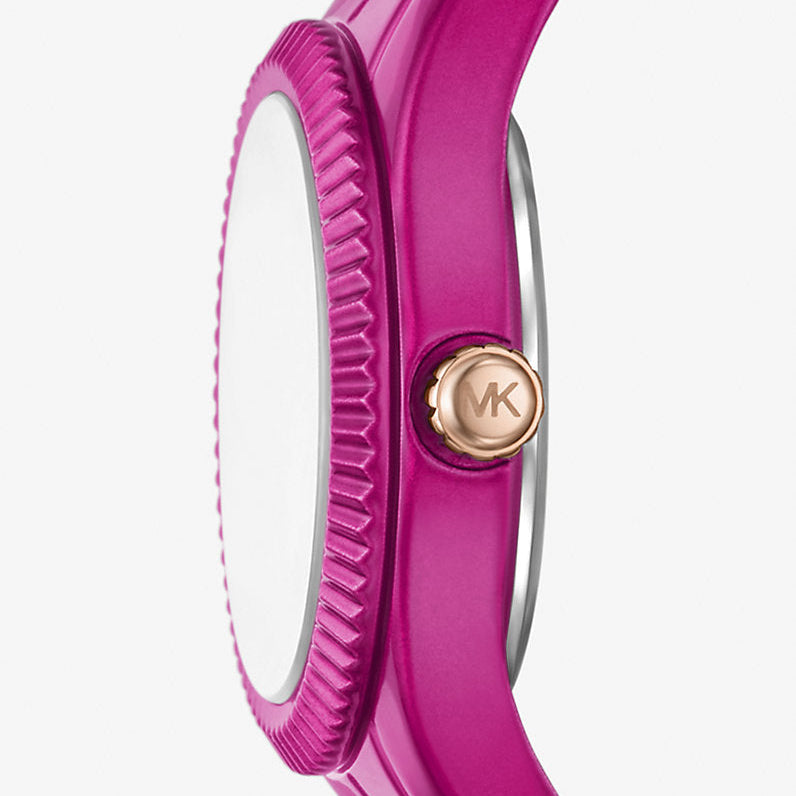 Angled real-life photo of Michael Kors MK4915LE showing the textured bezel and fuchsia case