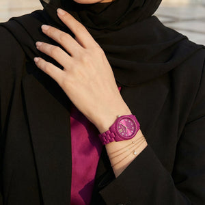 Lifestyle photo of Michael Kors MK4915LE showing the bold fuchsia watch on a woman's wrist