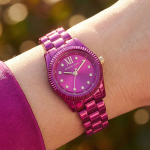 Close up shot of Michael Kors MK4915LE on wrist showing petite 26mm case and magenta dial