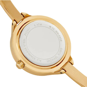Close-up of the back of a Michael Kors wristwatch with a gold-tone stainless steel case and matching metal strap on a white background.