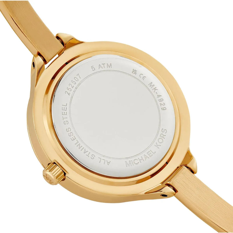 Close-up of the back of a Michael Kors wristwatch with a gold-tone stainless steel case and matching metal strap on a white background.
