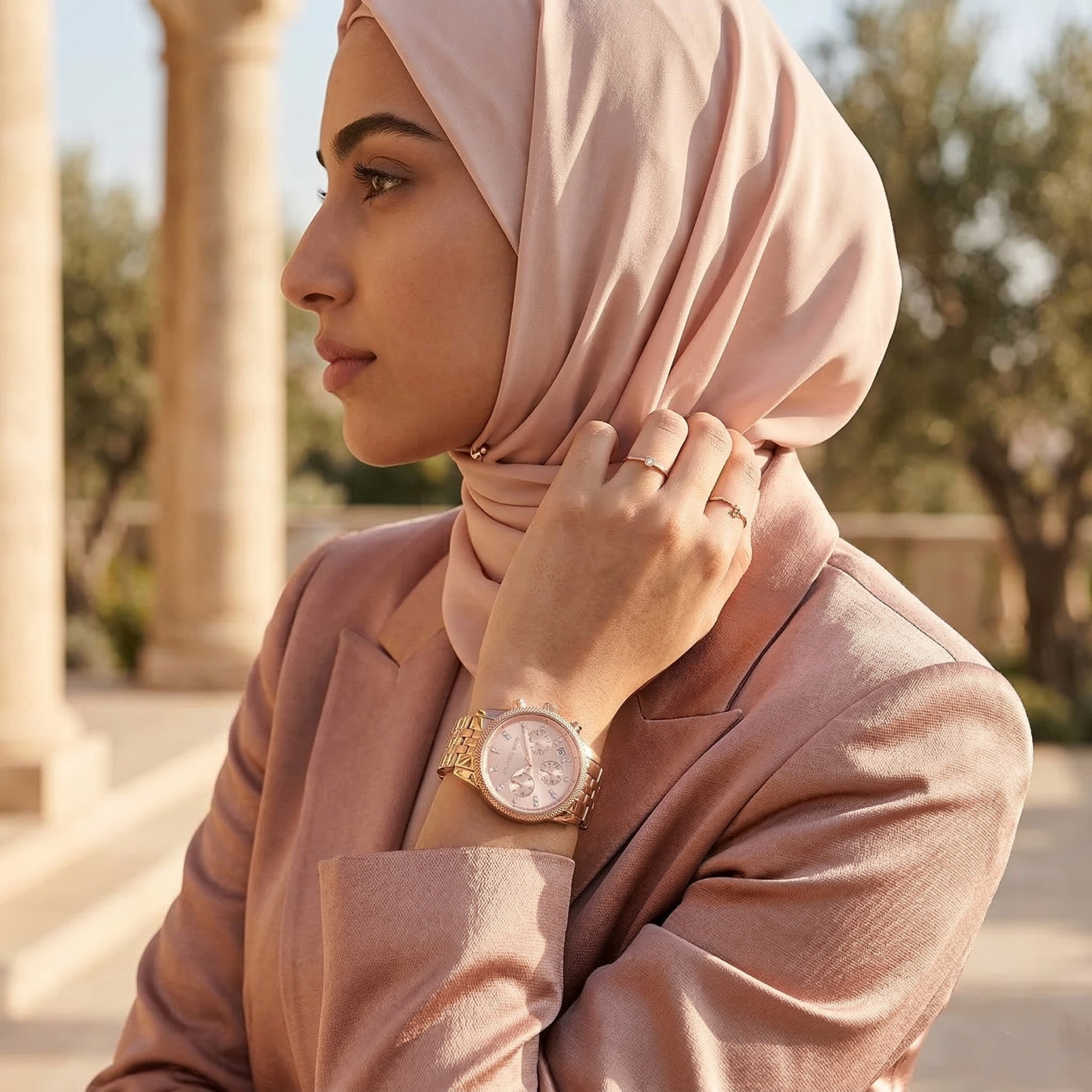 Elegant woman wearing Michael Kors Ritz MK6077 with rose gold-tone case and subtle crystal index markers luxury style watch