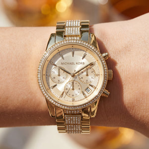 Close up shot of Michael Kors MK6484 on wrist showing gold dial and crystal chronograph sub-dials