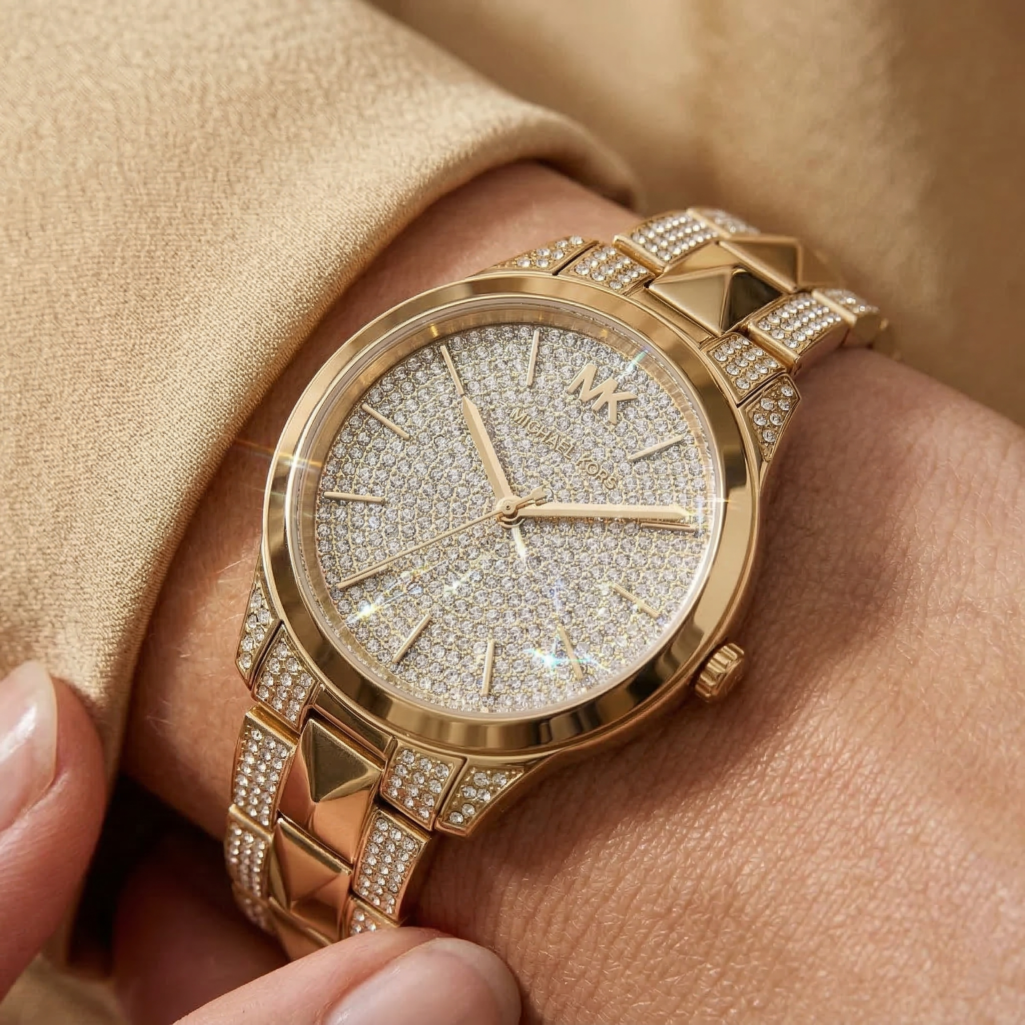 Close up of Michael Kors Runway Mercer MK6715 on wrist showing full pavé crystal dial and gold metal Mercer link bracelet
