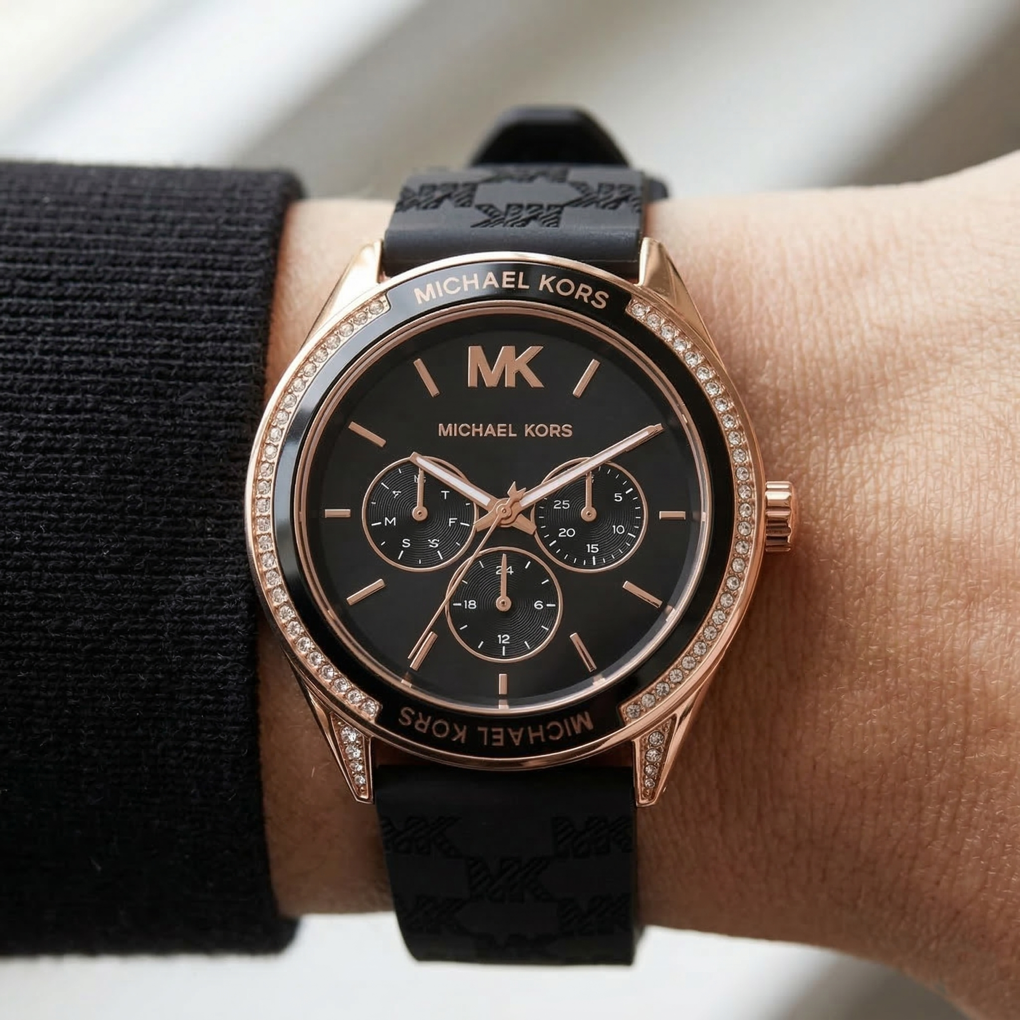 Close up of Michael Kors Jessa MK7266 women's quartz battery watch on wrist showing black multi-function dial and crystal bezel