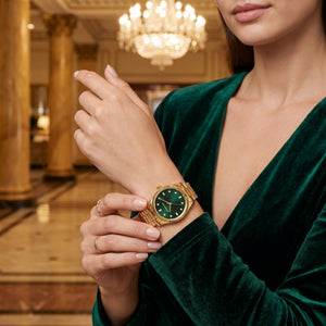 Lifestyle photo of Michael Kors MK7449 showing the elegant gold watch on a woman's wrist