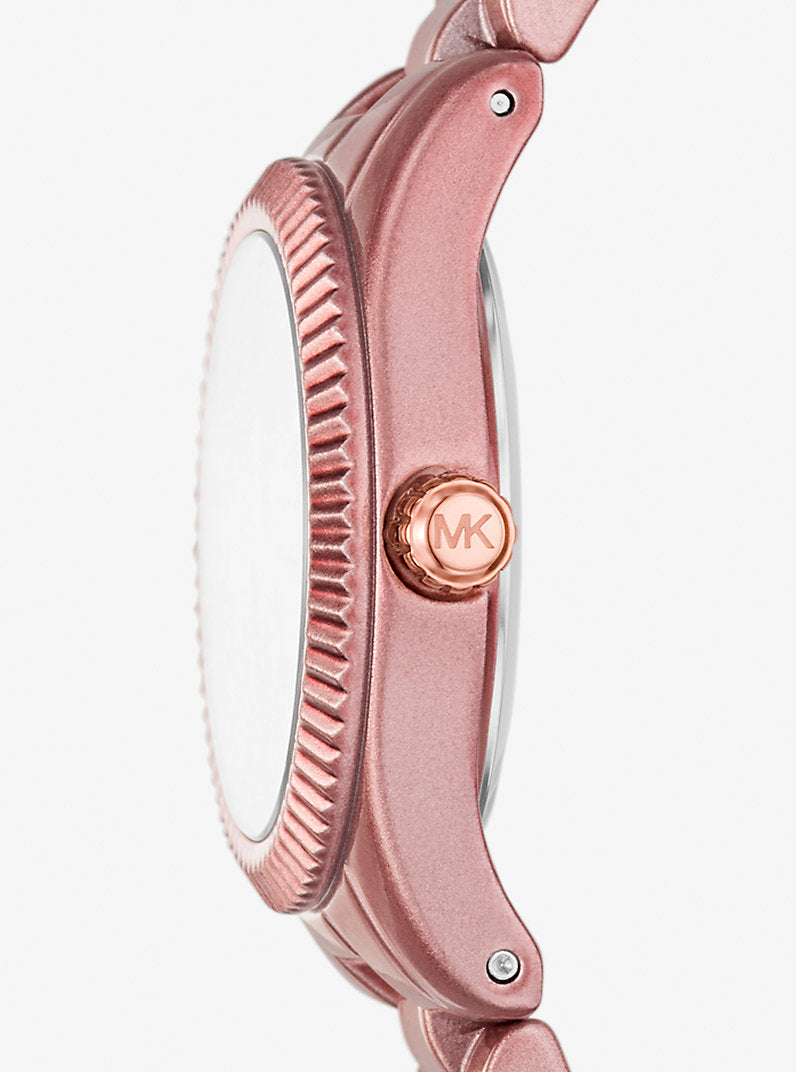 Angled real-life photo of Michael Kors MK7518LE showing the textured bezel and rose case