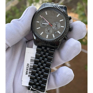 Live photo of Michael Kors Lexington MK8320 men's quartz battery watch showing actual black finish and iconic fluted bezel