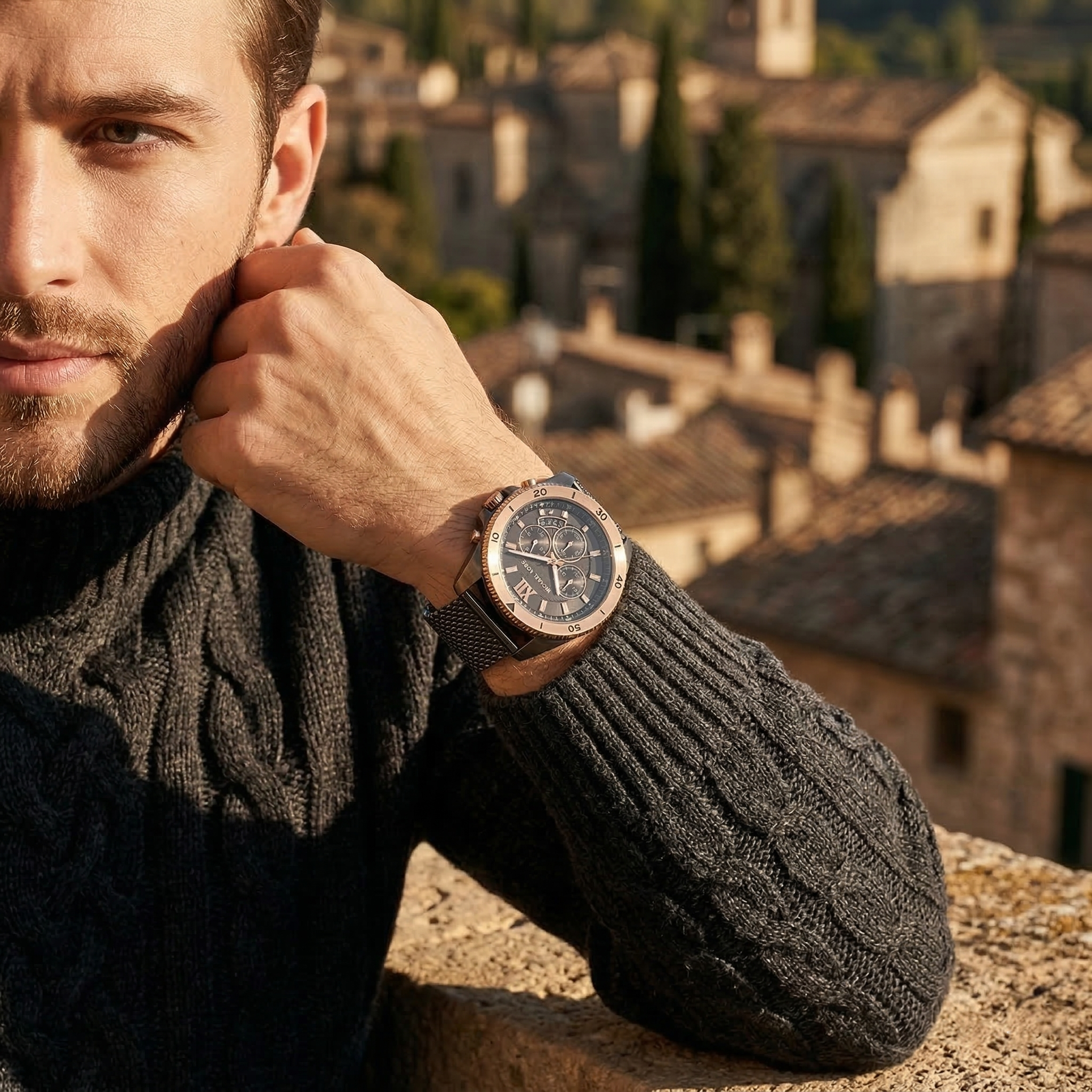 Elegant man wearing Michael Kors Brecken MK8868 men's quartz battery watch with grey-tone case and luxury rose gold bezel