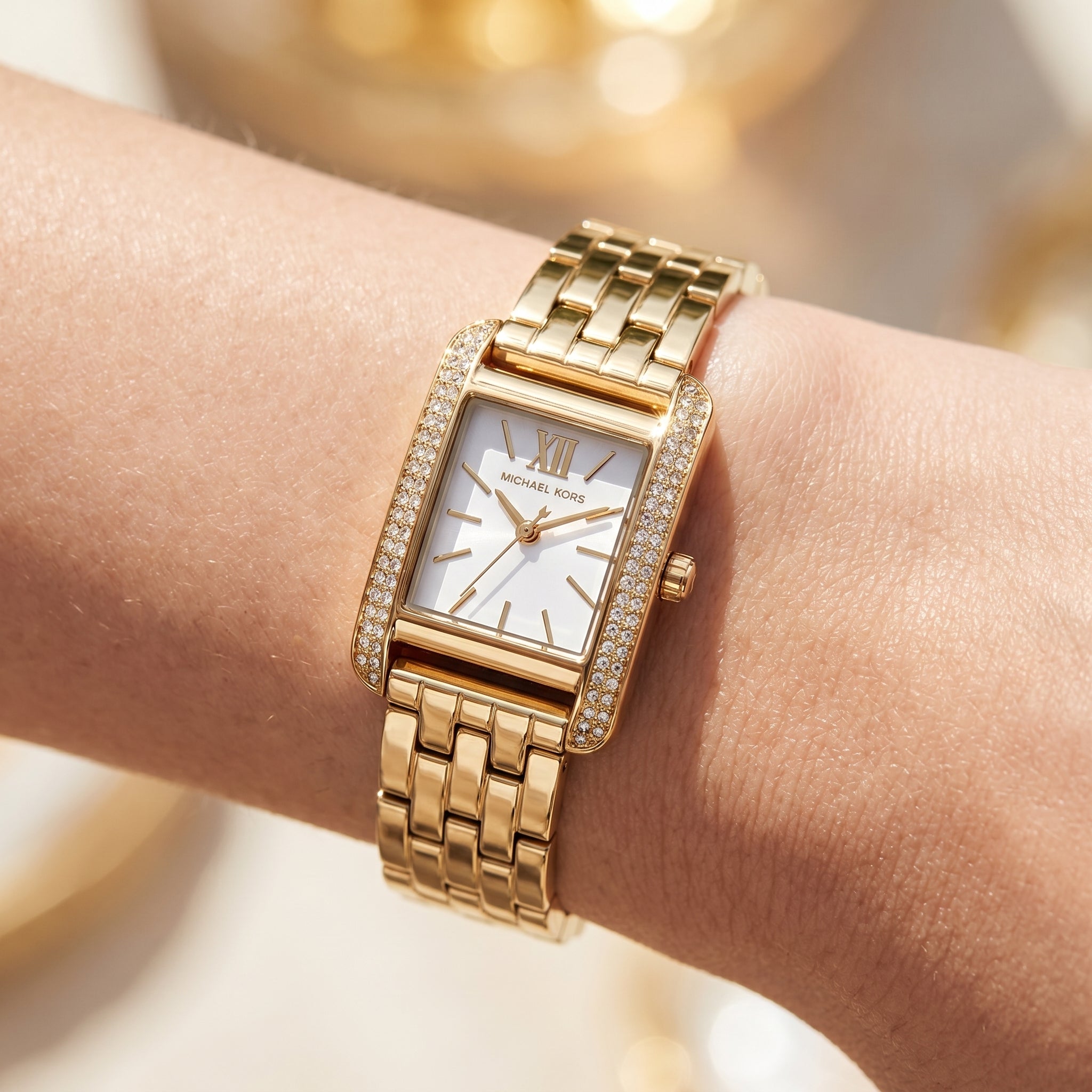 Close up shot of MKO1034 highlighting the white dial and gold stick markers with crystal accents