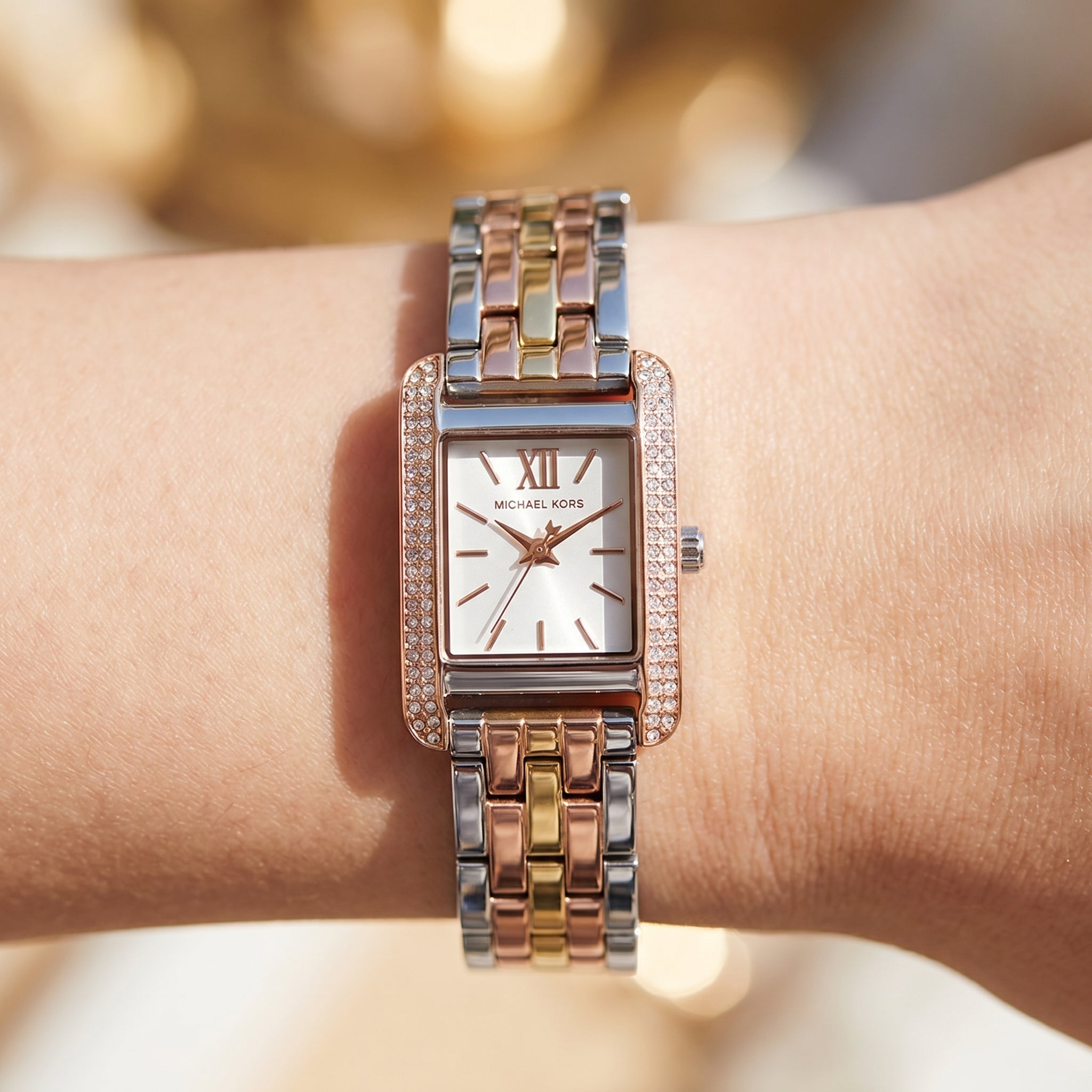 Close up shot of Michael Kors mko1146 on wrist showing white dial and rose gold-tone Roman numerals