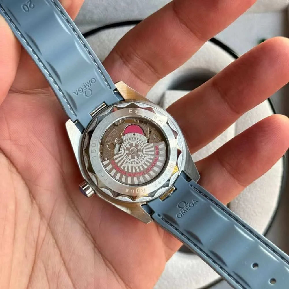 Omega Seamaster Aqua Terra men's automatic watch, 41mm stainless steel case, ice blue dial, light blue rubber strap – hand-held caseback view