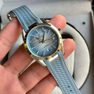 Omega Seamaster Aqua Terra men's automatic watch, 41mm stainless steel case, ice blue dial, light blue rubber strap – hand-held view