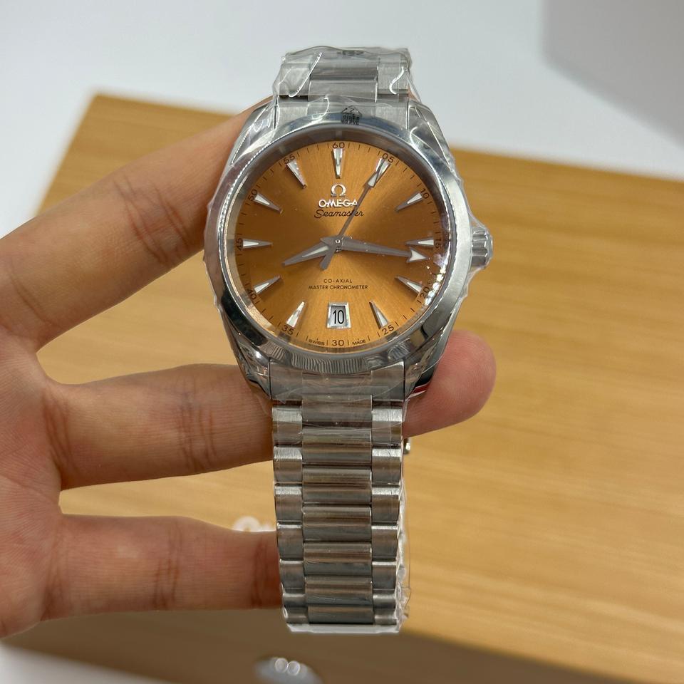Omega Seamaster Aqua Terra Shades 220.10.38.20.12.001 automatic watch, 38mm stainless steel case, orange dial, steel bracelet – hand-held view