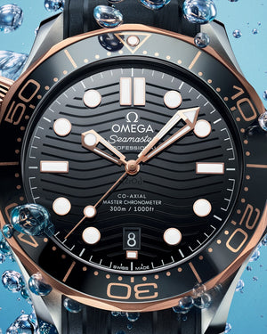 Omega Seamaster Diver 300M 210.22.42.20.01.002 men's automatic watch – black ceramic wave dial and Sedna gold bezel close-up