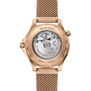 Omega Seamaster Diver 300M Bronze Gold men's automatic watch, 42mm bronze gold case, black dial, burgundy bezel, mesh bracelet – caseback movement view