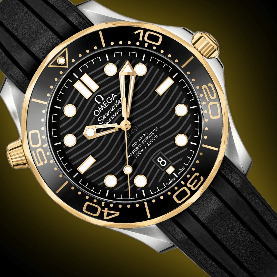 Omega Seamaster Diver 300M men's automatic watch, 42mm steel and yellow gold case, black dial, black rubber strap – dial close-up on dark background