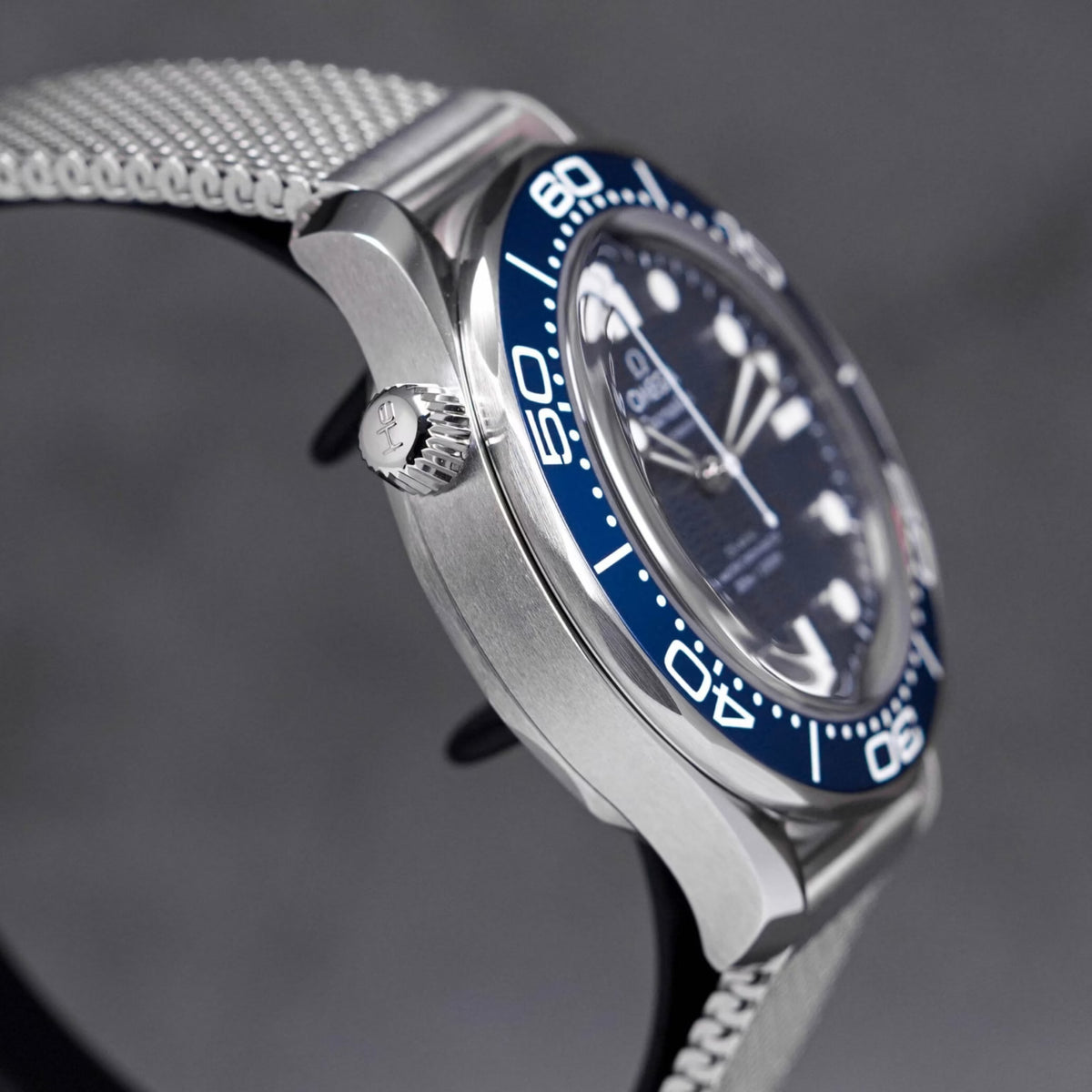 Omega Seamaster Diver 300M men's automatic watch, 42mm stainless steel case, blue ceramic bezel, mesh bracelet – right angle close-up