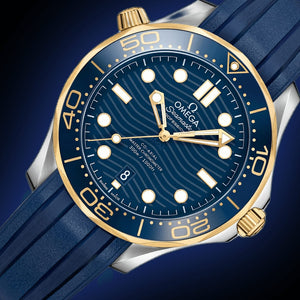 Omega Seamaster Diver 300M men's automatic watch, 42mm steel and yellow gold case, blue dial, blue rubber strap – dial angle on dark background