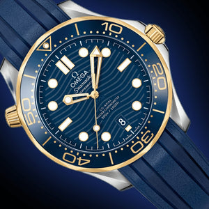 Omega Seamaster Diver 300M men's automatic watch, 42mm steel and yellow gold case, blue dial, blue rubber strap – dial close-up on dark background