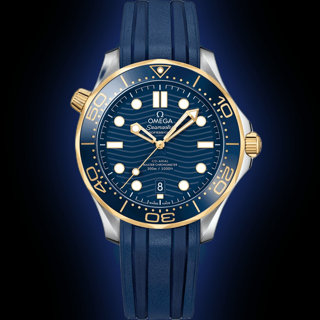Omega Seamaster Diver 300M men's automatic watch, 42mm steel and yellow gold case, blue dial, blue rubber strap – front view on dark background