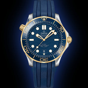 Omega Seamaster Diver 300M men's automatic watch, 42mm steel and yellow gold case, blue dial, blue rubber strap – front view on dark background