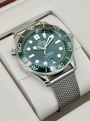 Omega Seamaster Diver 300M men's automatic watch, 42mm stainless steel case, green dial, mesh bracelet – angle view in box